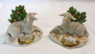 A pair of Samson Models of reclining sheep against sprouting bocages, decorated in naturalistic