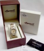 A Ladies boxed and unused Ingersoll gilt metal Dress Watch, the bezel and bracelet with small