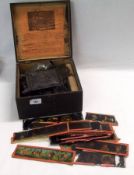 A German Tinplate Magic Lantern retained in original box; together with a small quantity of Glass