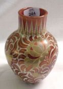 An English Lustre Ware Baluster Vase, gilded and decorated in puce lustre with twining foliage and