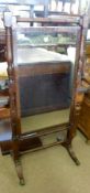 An early 19th Century Mahogany Cheval Mirror, with a ring-turned column surround and central mirror,