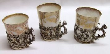 Three Victorian Silver Coffee Can Holders, each with cast and applied handles and pierced frames