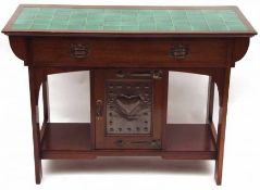 An Arts & Crafts Period Mahogany Wash Stand, inset with a green tiled top and the full width