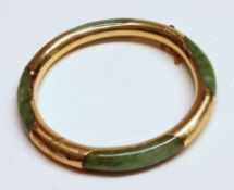 An Oriental yellow metal mounted Jade Bangle, 7cm diameter