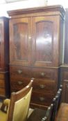 A Victorian Mahogany Converted Linen Press, with a moulded cornice over two arched panelled doors