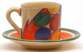 A Clarice Cliff Coffee Can and Saucer, decorated with the “Pebbles” design, orange colourway, with