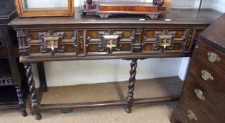 An Oak Dresser in Jacobean style, having three moulded panelled drawers to the frieze, top with