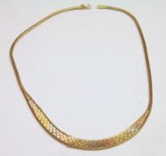 A high grade precious metal Tri-Colour Flexible Necklet, approximately 37cm long and weighing