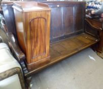 An 18th Century style Oak Settle, with five panelled back, curved sloping arms, solid panelled