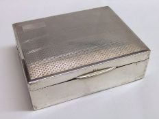 A George V Cigarette Box, of rectangular form, the hinged cover with engine-turned decoration and