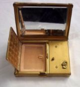 A mid-20th Century rectangular Gilt Metal Musical Compact in original cover