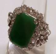 A Platinum rectangular Emerald Jade panelled Ring with eighteen brilliant cut Diamonds in