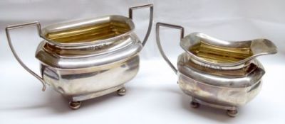A George V Sugar Basin and Milk Jug, each of polished rectangular form with waisted throats and each