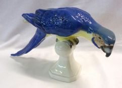 A Royal Dux Bohemian Model of a perched parrot, decorated predominantly in underglaze blue with