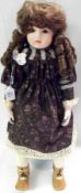 A Bisque Head and Shoulder Plate Bruu (reproduction) Doll, with brown fixed glass eyes, painted