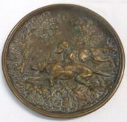 A Cast Brass Plate of circular form, decorated with two retrievers, diameter 7”