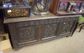An early 18th Century Carved Oak Coffer with four panel top and three panel front, carved with