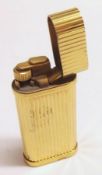 A late 20th Century Gold Plated Gas Cigarette Lighter, Cartier, of oval form with hinged and