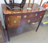 An early 19th Century Mahogany small Sideboard, bow front over central frieze drawer, and with