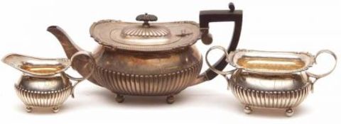 An Edward VII Three Part Tea Set comprising Teapot, Sugar Basin and Milk Jug, each of half-fluted