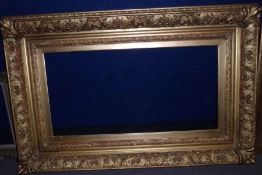 GOOD VICTORIAN GILT GESSO CUSHIONED PICTURE FRAME, with ornate floral and scrolled edges and shell