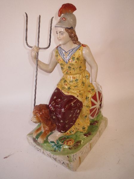 C19th Staffordshire pottery model of Britannia seated on chariot & holding a triton, lion at her