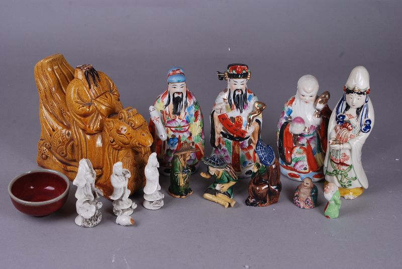 A collection of Chinese porcelain figures and a red glazed bowl, C18th and later, 18.8cm high max.