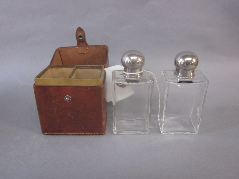 Two glass flasks in leather holder, John Pound, London