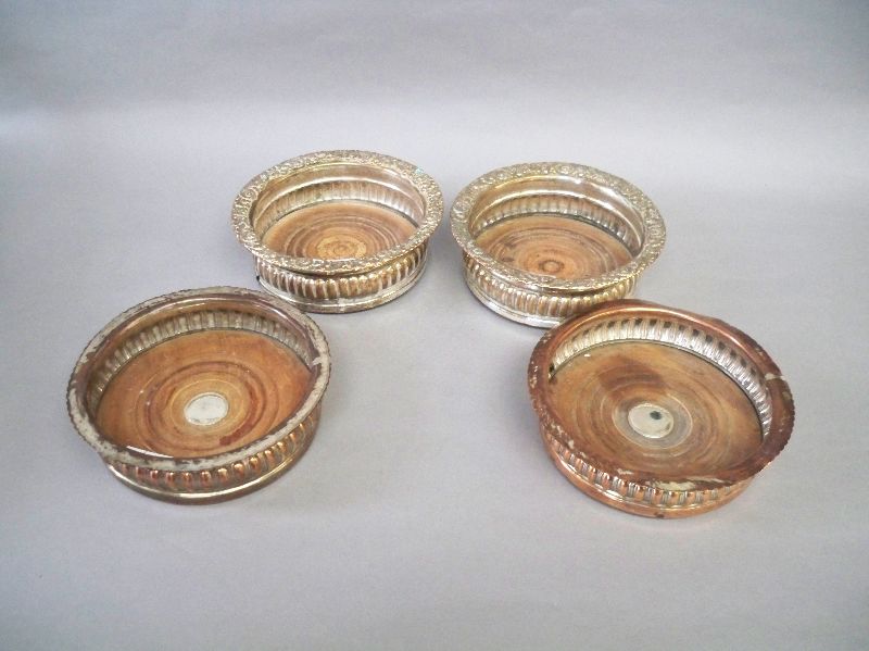 Harlequin set of four reeded bottle coasters with embossed floral rims 15dia