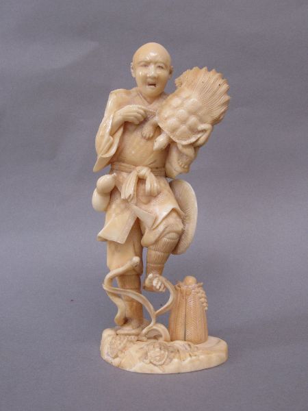 Ivory Okimono as a figure from Japanese mythology with a sea turtle & a serpent around his leg 17H
