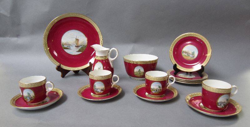 C19th part tea set with countryside hand painted reserves to a maroon ground (15)