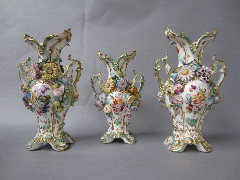 C19th Rococo porcelain vase garniture with applied painted floral decoration 33H & smaller