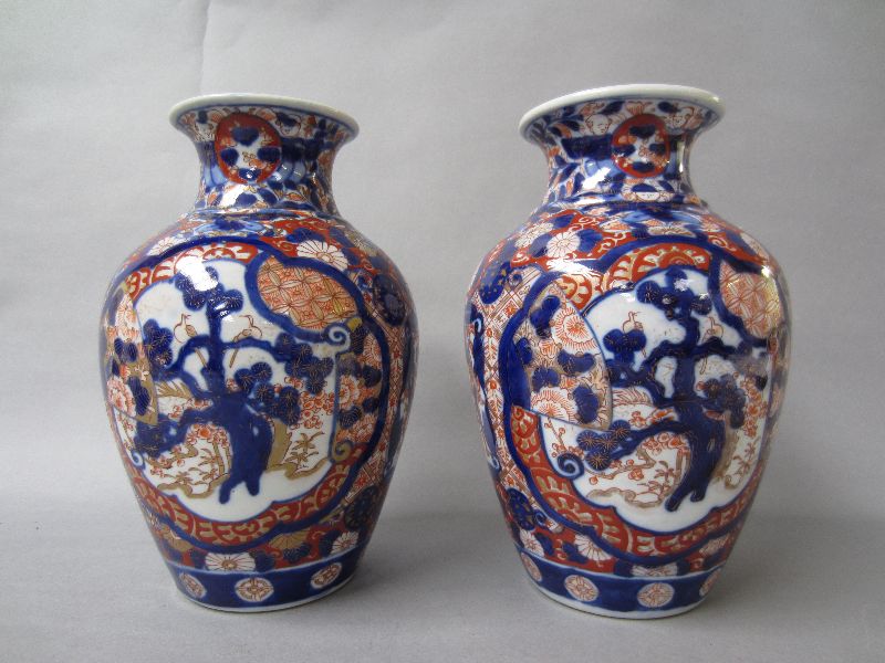 Pair of early C20th Imari pattern ovoid porcelain vases with everted rim 25 H