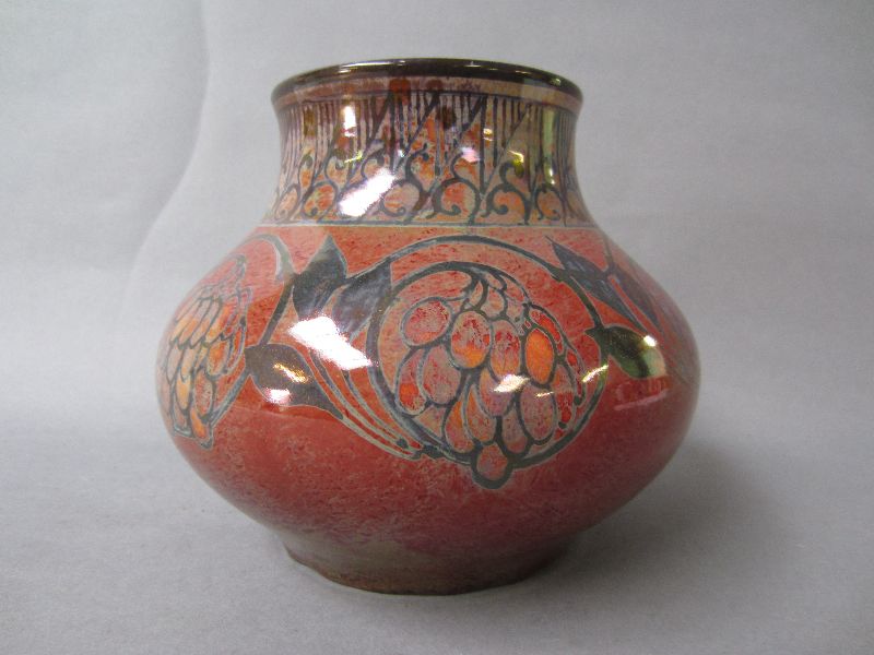 Pilkingtons Royal Lancastrian lustre elderberry vase with a maroon ground 14.5 H