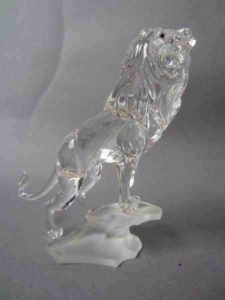 Swarovski lead crystal mint & boxed figure group of a lion stood on rocky base, "Rare Encounters"