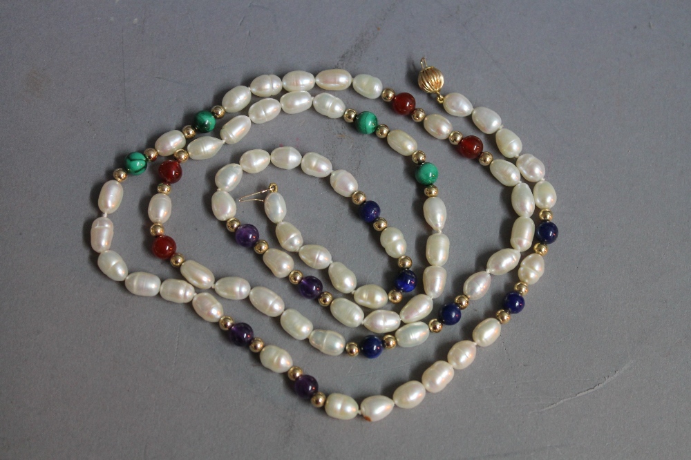 A cultured pearl and hard stone 14ct. gold necklace, the baroque cultured pearls alternating with