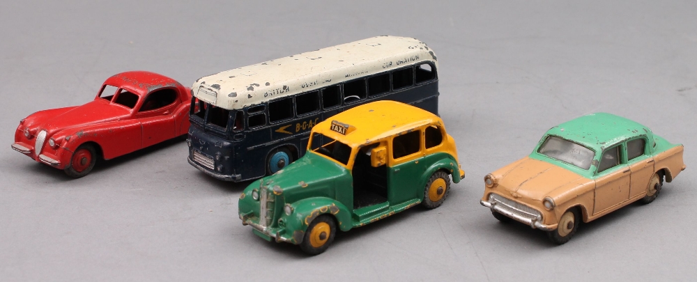 Four dinky cars: Austin taxi no.254; a bus no.283; Hillman Minx no.175 and a Jaguar no.157.