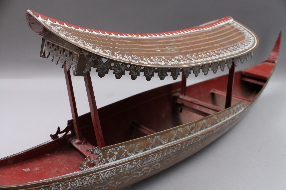 An Oriental part painted bronzed model boat, 73cm long.