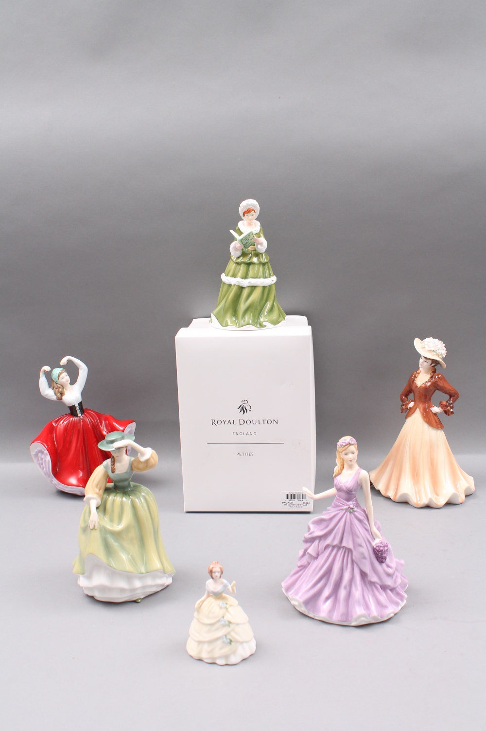 A boxed Royal Doulton `Ninth Day of Christmas` figure, two Royal Doulton Pretty Ladies figures `