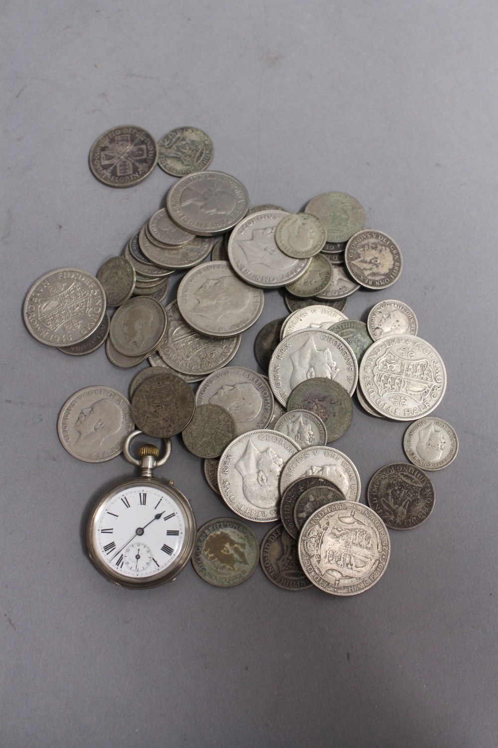 A quantity of pre 1947 British half silver coins to include: half crowns, shillings etc. weighing