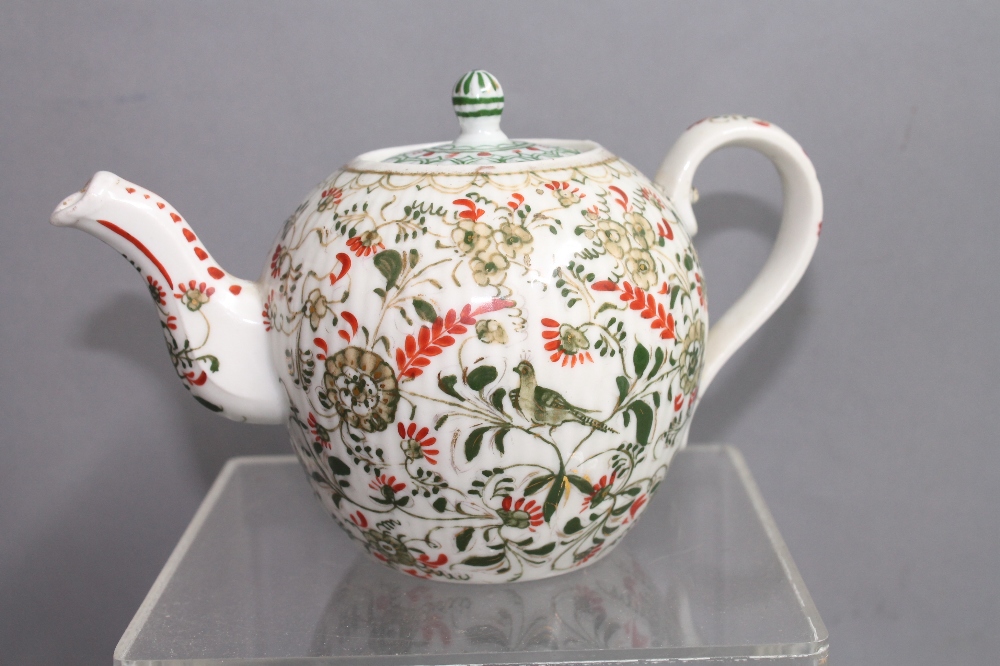 A bullet shaped teapot with red and green enamelled and gilt decoration, possibly Russian, 11cm