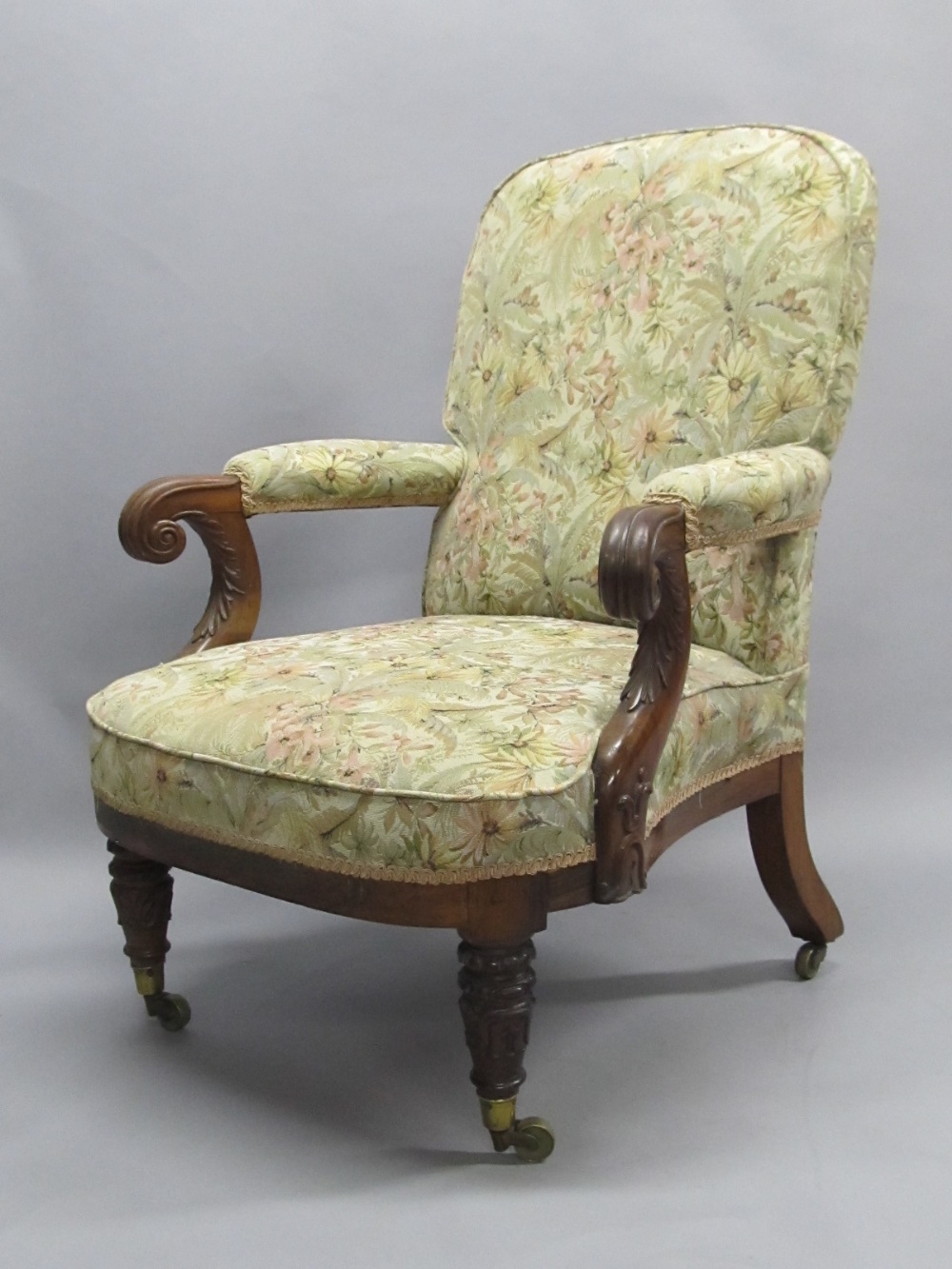 A William IV carved rosewood framed upholstered library chair.
