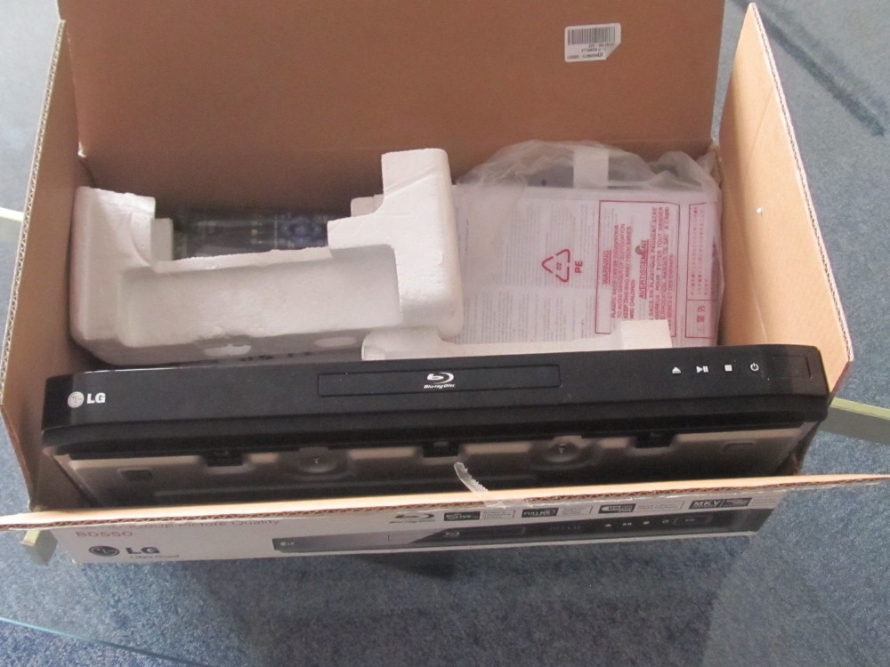 A boxed LG blu-ray player, with remote (sold as parts, means lead removed)