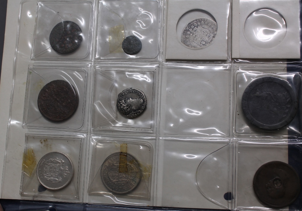 An album of assorted coins to include 1744 Portuguese coin, Victorian silver crown, florins,
