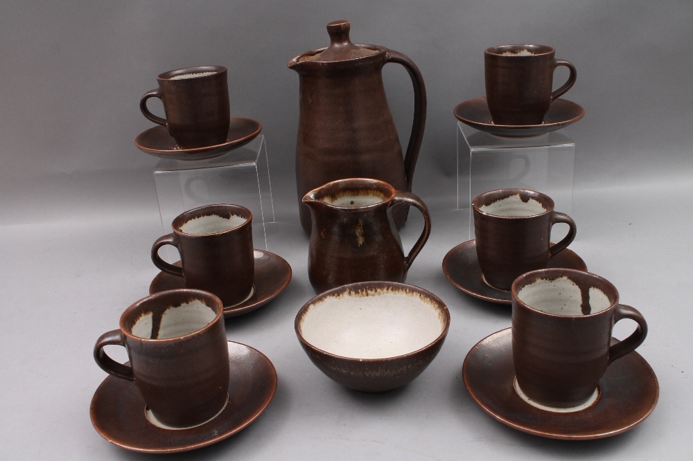 A studio pottery coffee set, comprising coffee pot, sugar bowl cream jug and six cups and saucers,