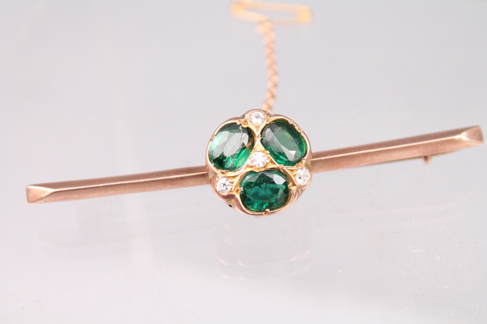 A green stone and diamond set rose gold bar brooch, c. 1900, gross weight 7.5 grams.