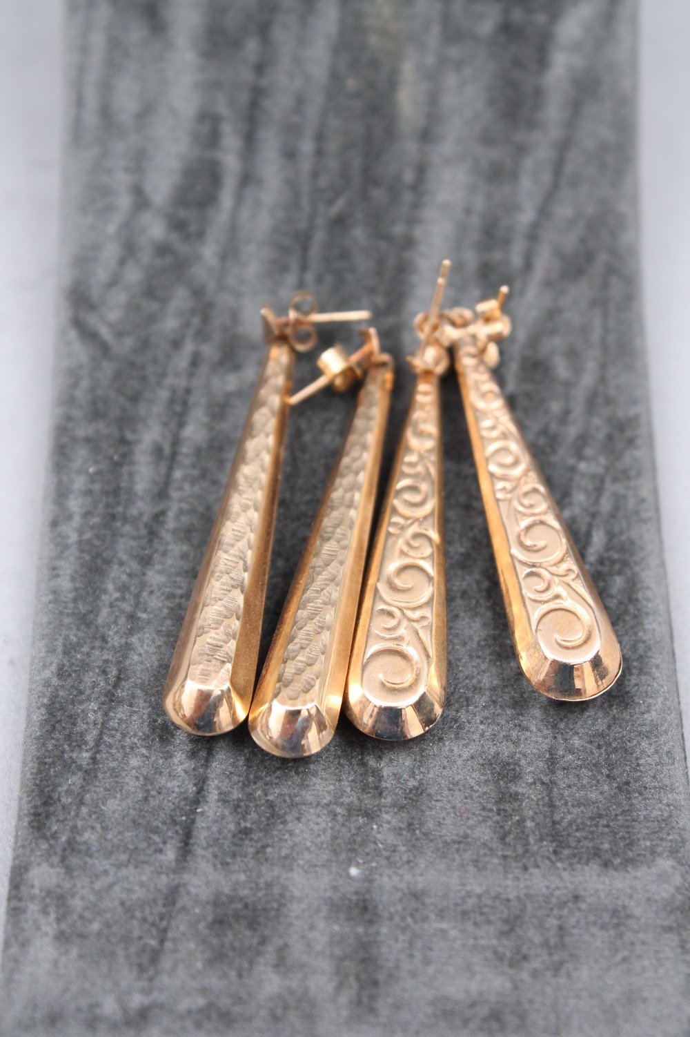Two pairs of gold torpedo shaped drop earrings 45mm long, weighing a total of approx 4.1 grams.