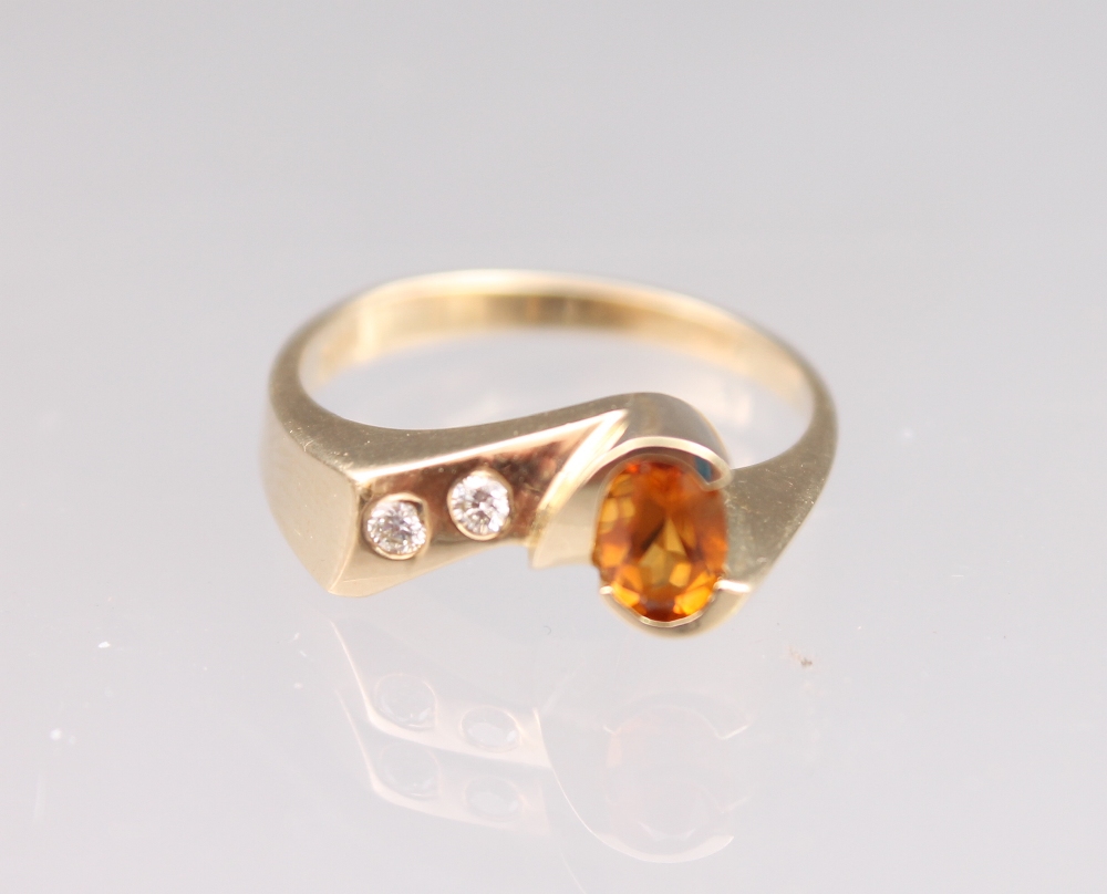 A citrine and diamond three stone dress ring set in a 14ct yellow gold modern design ring, gross