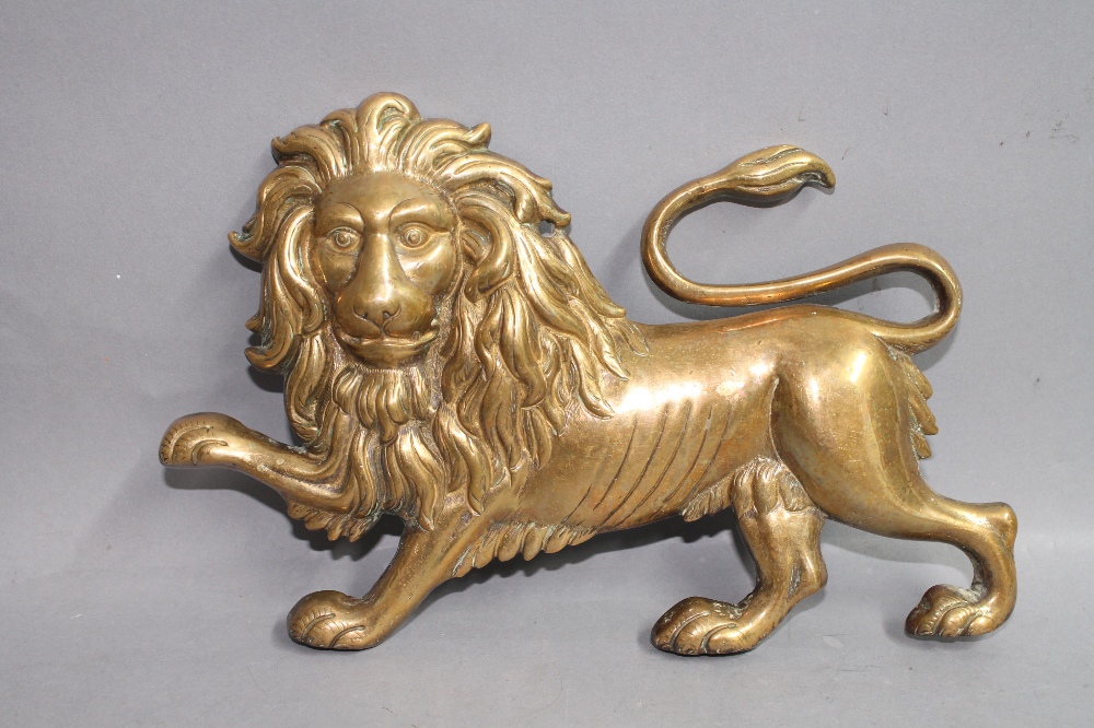 A bronze wall plaque modelled as a rampant lion, length approx 22cm.