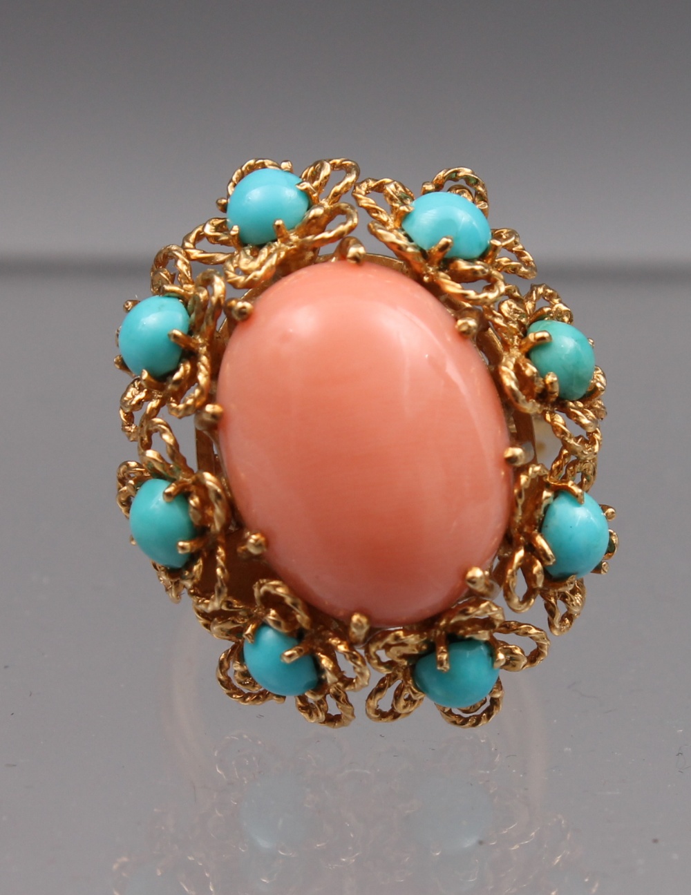An 18ct gold coral and turquoise cluster ring, the filigree cluster design head 30mm long, total